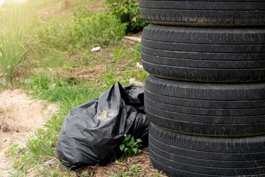 Four used and lined tires. And there was a black garbage bag next to the lawn on the roadside.