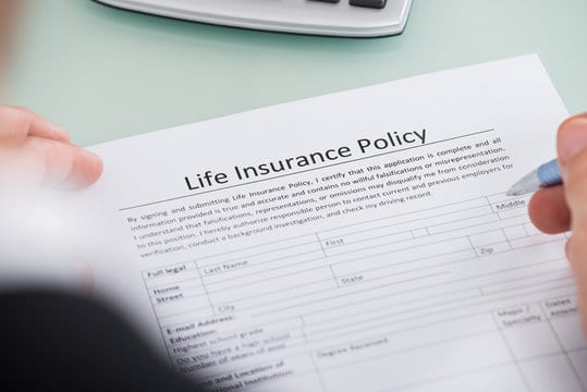 Person Filling Life Insurance Policy Form