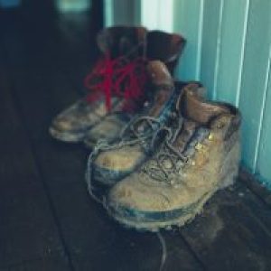 Two. pair of muddy boots in entrance