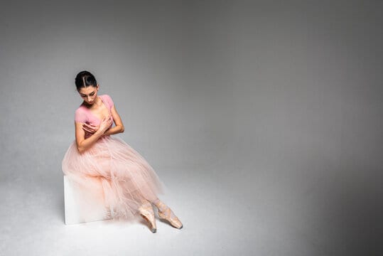 pretty ballerina. A young elegant ballet dancer, dressed in professional attire, shoes and a pink we