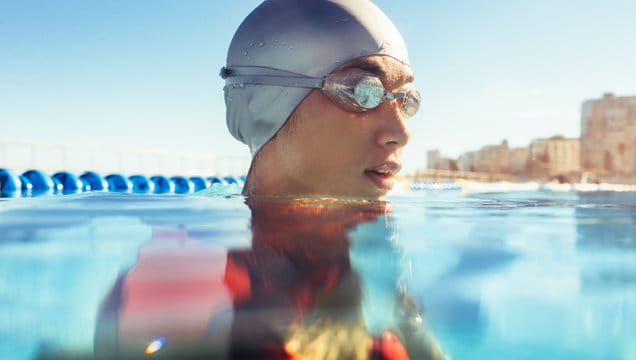 Female athlete in swim cap and goggles